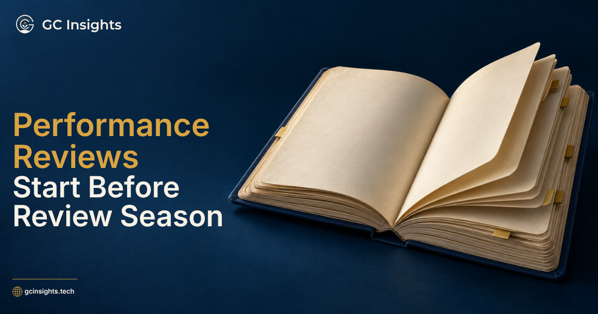 Performance Reviews Start Before Review Season” beside an open journal with layered pages and gold markers.