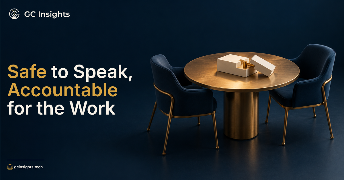 “Safe to Speak, Accountable for the Work” beside two chairs facing a shared table with an unfinished assembly.